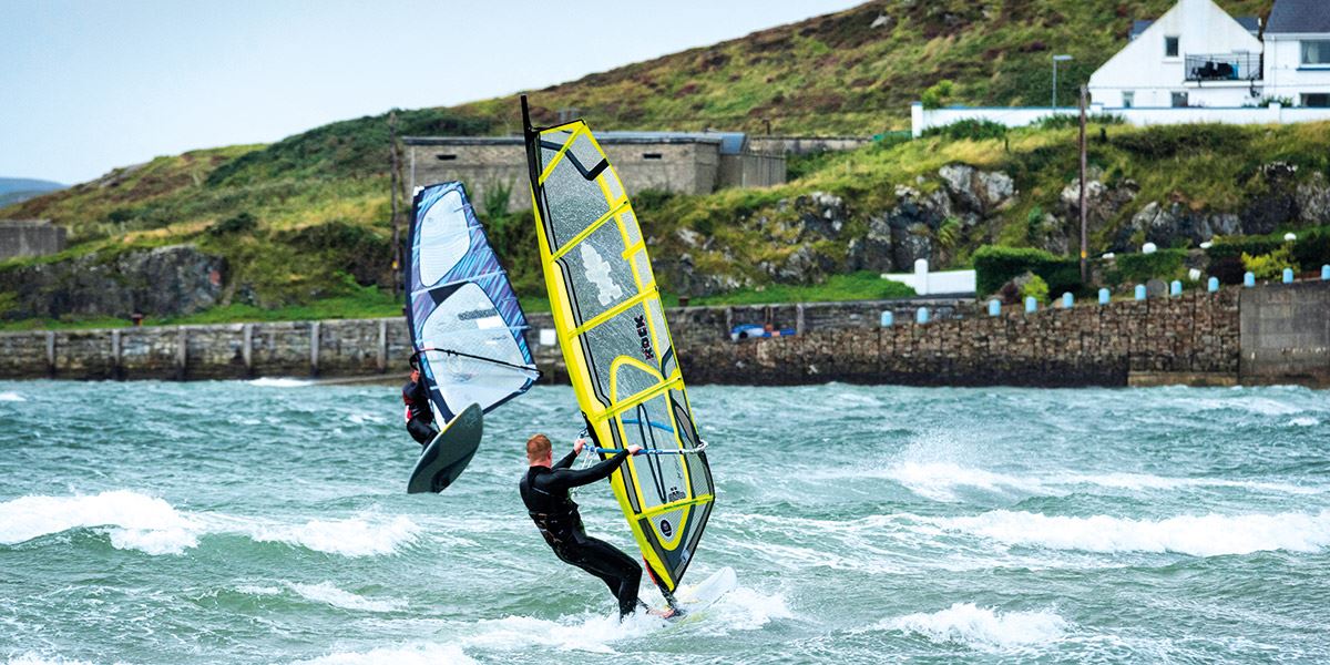 Two windsurfers in sea