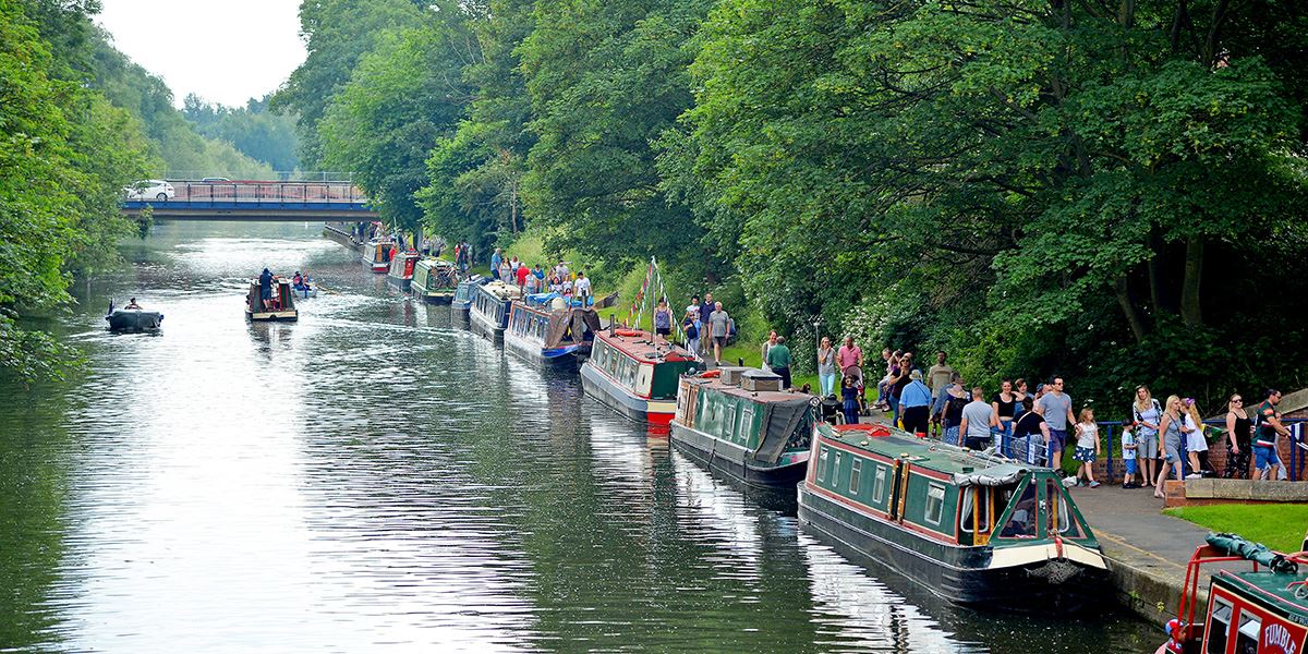 Narrowboats lined up on the River Soar
