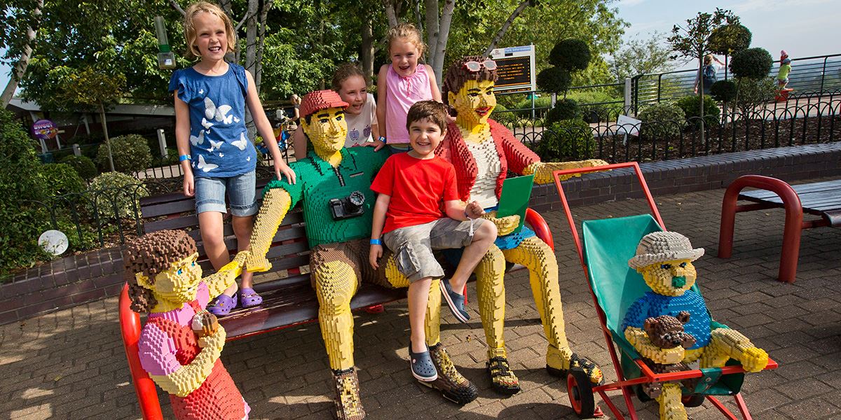 Family with lifesize lego people at Legoland Windsor Resort