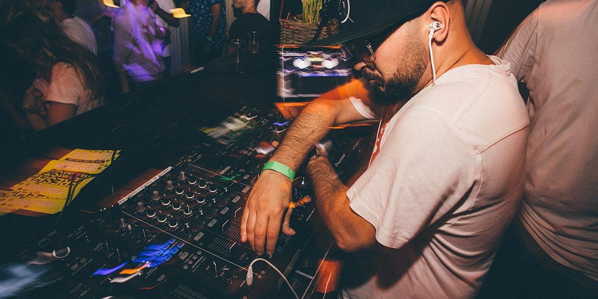 DJ using their decks in a nightclub