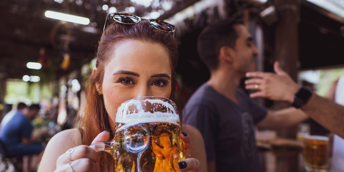 Woman drinking a beer out of an stein