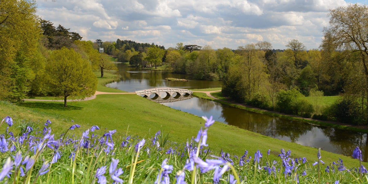 Five Arch bridge with bluebells in Painshill Park, Surrey