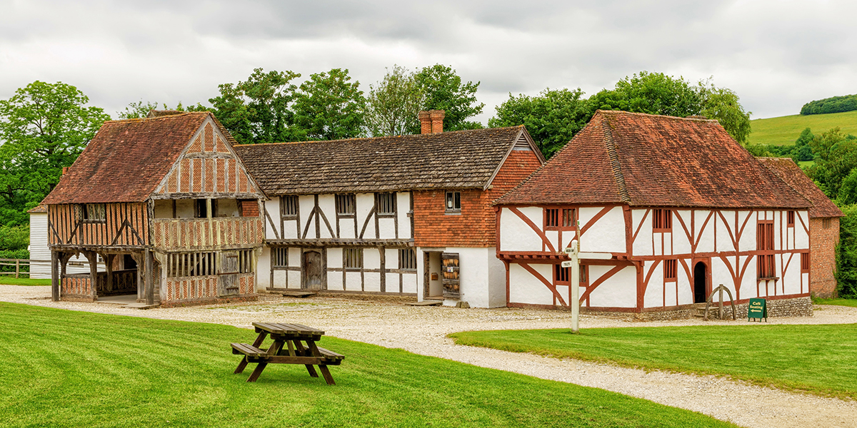Thirteenth century medieval buildings built of wood, lath and plaster at the Weald and Downland open air Museum, Sussex, England, surrounded by parkland.
