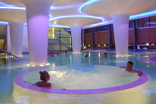 People relaxing in a hot tub at Thermae Bath Spa