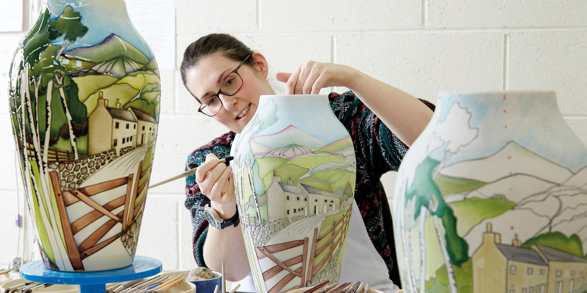 woman painting large pot